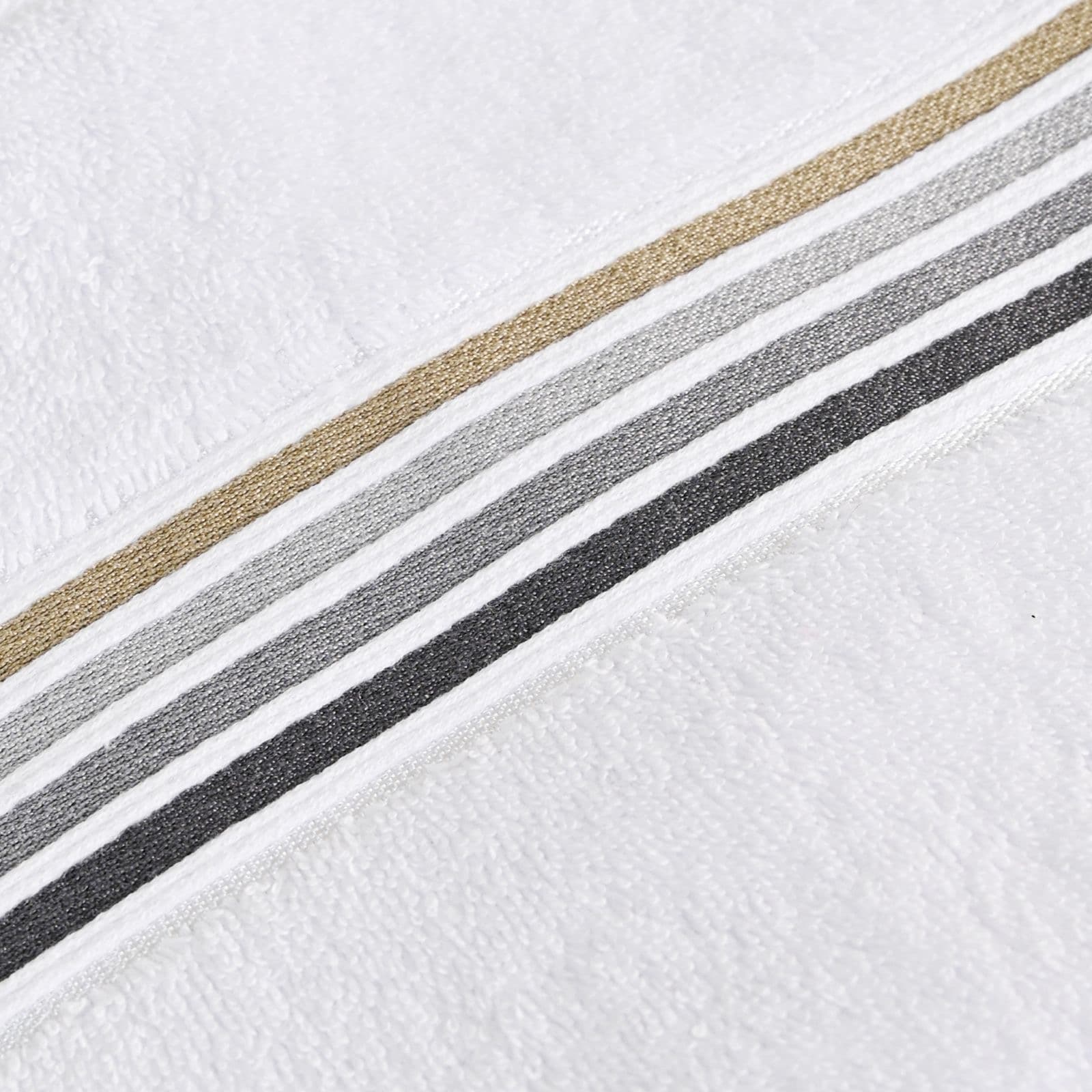 White terry towel with a woven border in tan, grey and black